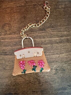 Embellished Tan Leatherette Charm Keychain with Bedazzled Pink Flower Accents.